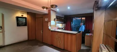 a man standing at a counter in a kitchen at Departamento Plaza San Martín in Cordoba