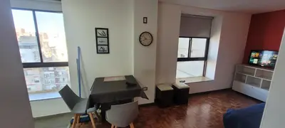 a living room with a desk and a piano at Departamento Plaza San Martín in Cordoba