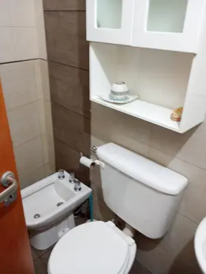 a small bathroom with a toilet and a sink at La Carolina Cabañas in Almafuerte