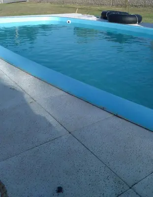 a large swimming pool with a blue end at La Carolina Cabañas in Almafuerte