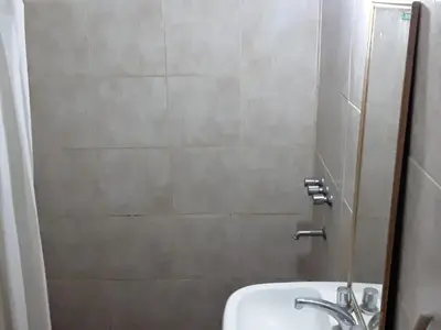 a small bathroom with a sink and a shower at El Dpto de Gabicito V in Cordoba