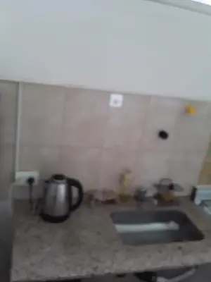a kitchen counter with a sink and a tea kettle at El Dpto de Gabicito V in Cordoba