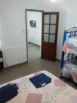 a room with a bedroom with a bed and a door at El Dpto de Gabicito V in Cordoba