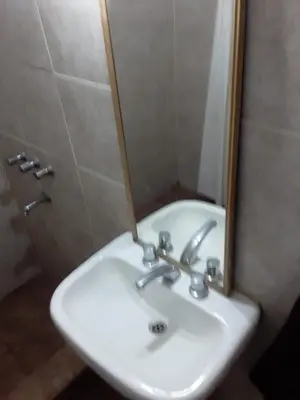 a white sink in a bathroom with a mirror at El Dpto de Gabicito V in Cordoba