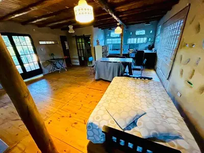 a room with a bed and a table in it at Tierra de Arroyo, Mallin-Tanti in Tanti