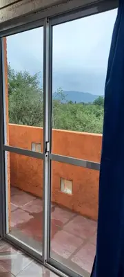 an open sliding glass door with a view at La curva del molino in Villa Parque Siquiman