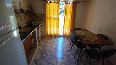 a kitchen with a table with chairs and a dining room at El Rincón de Siquiman in Villa Parque Siquiman