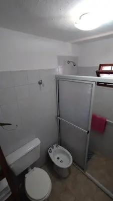 a small bathroom with a toilet and a sink at El Rincón de Siquiman in Villa Parque Siquiman