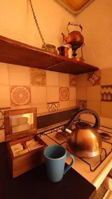 a tea kettle on a stove in a kitchen at El Rincón de Siquiman in Villa Parque Siquiman