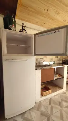 a model of a kitchen with an open refrigerator at El Rincón de Siquiman in Villa Parque Siquiman