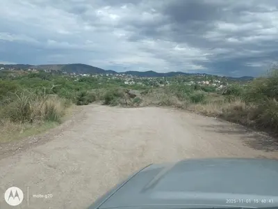 a car driving down a dirt road at CASA ANTONIO-sobre el rio in Villa Carlos Paz