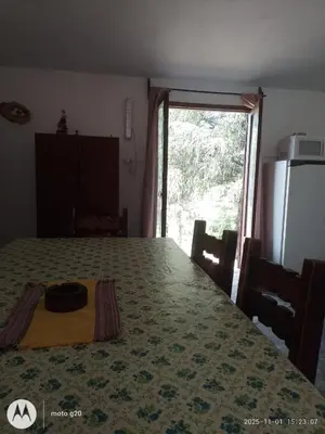 a room with a large table with a large window at CASA ANTONIO-sobre el rio in Villa Carlos Paz