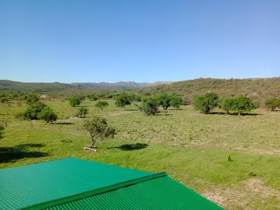 an overhead view of a green tennis court in a field at Cabaña Elun in Panaholma