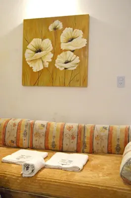 a couch with a picture of flowers on the wall at Apartamento del Sol para 5 in Villa Carlos Paz