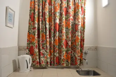 a shower curtain in a bathroom with a sink at Apartamento del Sol para 5 in Villa Carlos Paz