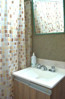 a bathroom with a sink and a mirror at Apartamento del Sol para 5 in Villa Carlos Paz