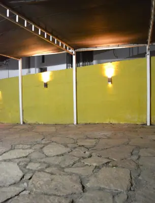 a yellow wall in a building with lights on it at Apartamento del Sol para 5 in Villa Carlos Paz