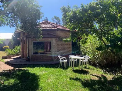 a small house with two chairs and a table at Casita de campo in Villa Ciudad Parque