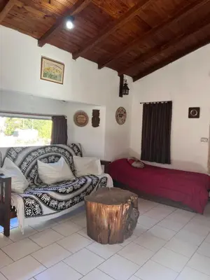 a living room with a couch and a coffee table at Casita de campo in Villa Ciudad Parque