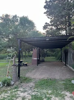 a picnic shelter with a picnic table in a park at Cabañas El Chañar in Villa Santa Cruz del Lago