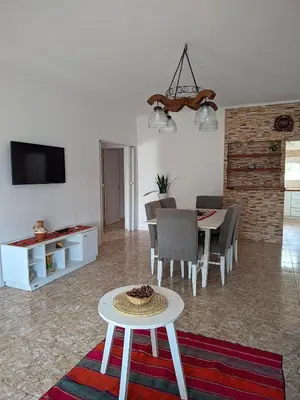 a living room with a table and a dining room at Luna Vallista House in Mina Clavero