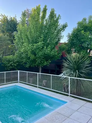a swimming pool with a fence around it at Luna Vallista House in Mina Clavero