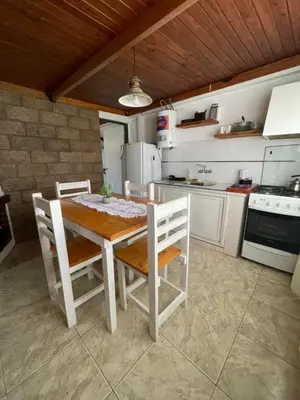 a kitchen with a table and chairs in a room at Lo del Turco in La Porteña