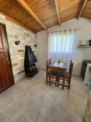 a living room with a table and a fireplace at Lo del Turco in La Porteña
