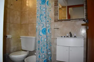 a bathroom with a toilet and a sink at Sierras Del Molle in Santa Rosa de Calamuchita