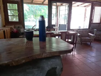 a wooden table with a vase on top of it at Casa Amueblada en Las Albahacas in Piedras Blancas
