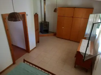 a living room with a couch and a stove at Casa Amueblada en Las Albahacas in Piedras Blancas