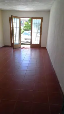 an empty room with two doors and a tiled floor at Casa Amueblada en Las Albahacas in Piedras Blancas