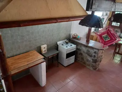 a small kitchen with a stove and a table at Casa Amueblada en Las Albahacas in Piedras Blancas