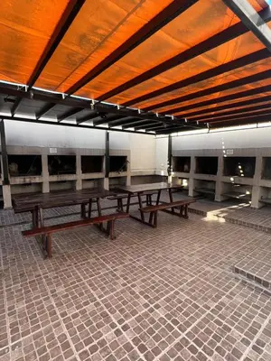 a group of picnic tables in a building at Luz del Lago in Villa Carlos Paz