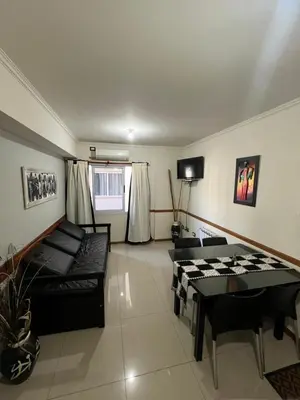a living room with a couch and a table at Luz del Lago in Villa Carlos Paz