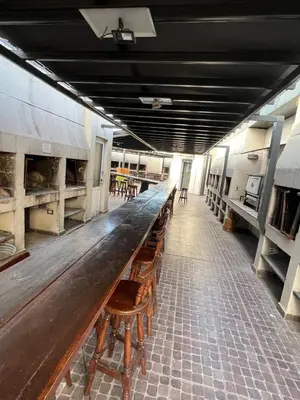 a long wooden table in a room with benches at Luz del Lago in Villa Carlos Paz