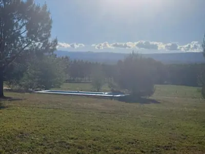 a field with a pond in the middle of a field at Bosquemolinos in Villa Los Molinos