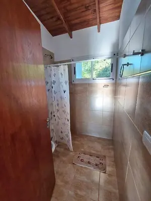a bathroom with a shower and a shower curtain at Bosquemolinos in Villa Los Molinos