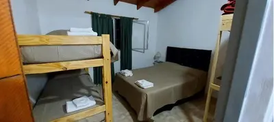 a small room with two bunk beds in it at Cabañas y departamentos Sol y Luna in Villa General Belgrano