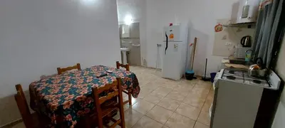 a small kitchen with a table and a stove and refrigerator at Cabañas y departamentos Sol y Luna in Villa General Belgrano