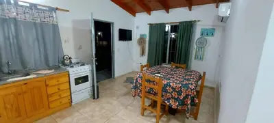a small kitchen with a table and a stove at Cabañas y departamentos Sol y Luna in Villa General Belgrano