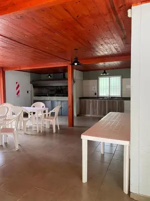 a kitchen and dining room with a table and chairs at Cabañas Esmeralda in Villa Ciudad de America