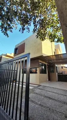 a building with a fence in front of it at Duplex Villa Carlos Paz in Villa Carlos Paz
