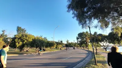 a group of people riding bikes down a street at Duplex Villa Carlos Paz in Villa Carlos Paz