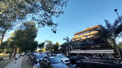 a city street with parked cars and a building at Duplex Villa Carlos Paz in Villa Carlos Paz