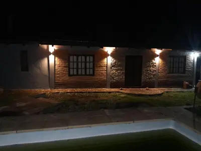 a house with lights on the side of it at night at Rincón de Nina in Tanti
