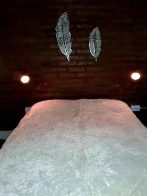 a bed covered in snow in a room with lights at Rincón de Nina in Tanti