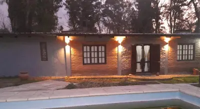 a house with lights on the front of it at Rincón de Nina in Tanti