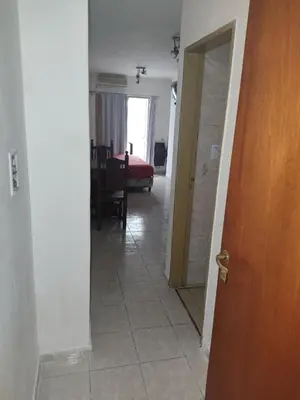 a hallway with a door and a room with a table at San Jerónimo Residential Apartaments in Cordoba