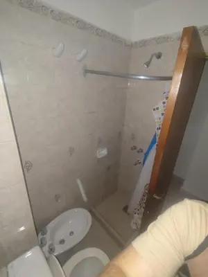 a bathroom with a shower and a toilet and a sink at San Jerónimo Residential Apartaments in Cordoba